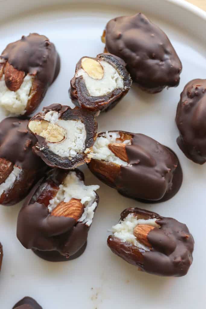 Healthy Chocolate Covered Almond Joy Stuffed Dates on a white plate 