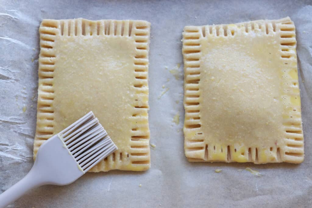 brushing freshly milled pop-tarts with an egg wash