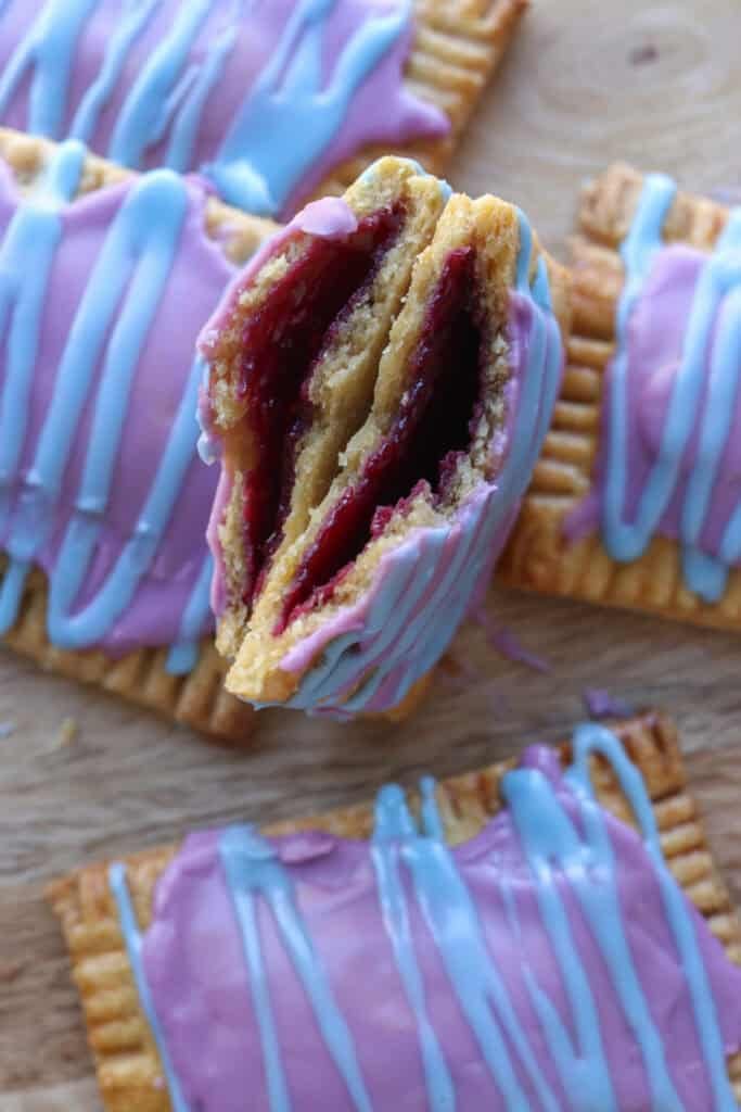 A freshly milled homemade wild berry pop-tart cut in half with jam in the middle