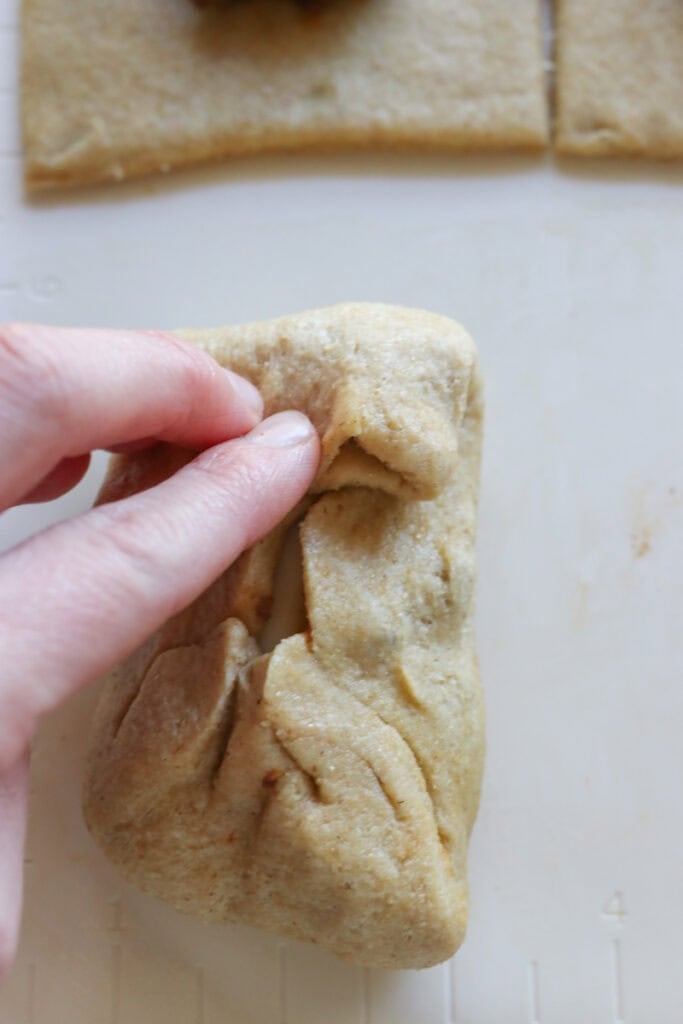 pinching dough together to make fresh milled cheesy taco pockets