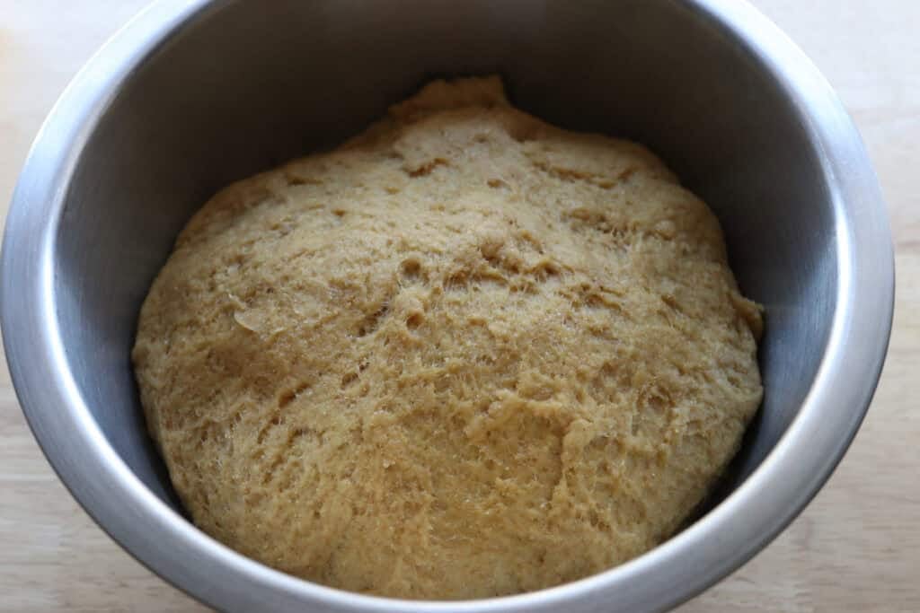 Fresh milled cheesy taco pocket dough that has risen in a bowl