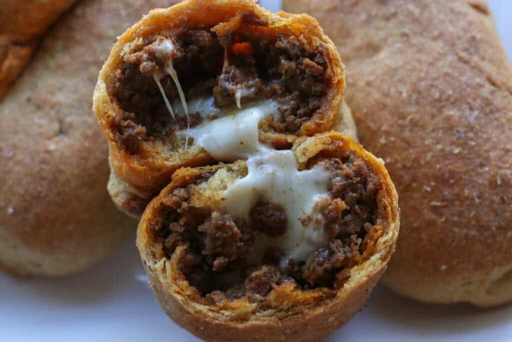 a fresh milled cheesy taco pocket cut in half and filled with cheese