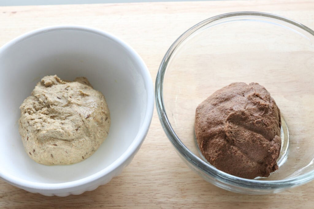 light and dark dough in bowls to make freshly milled marbled rye bread