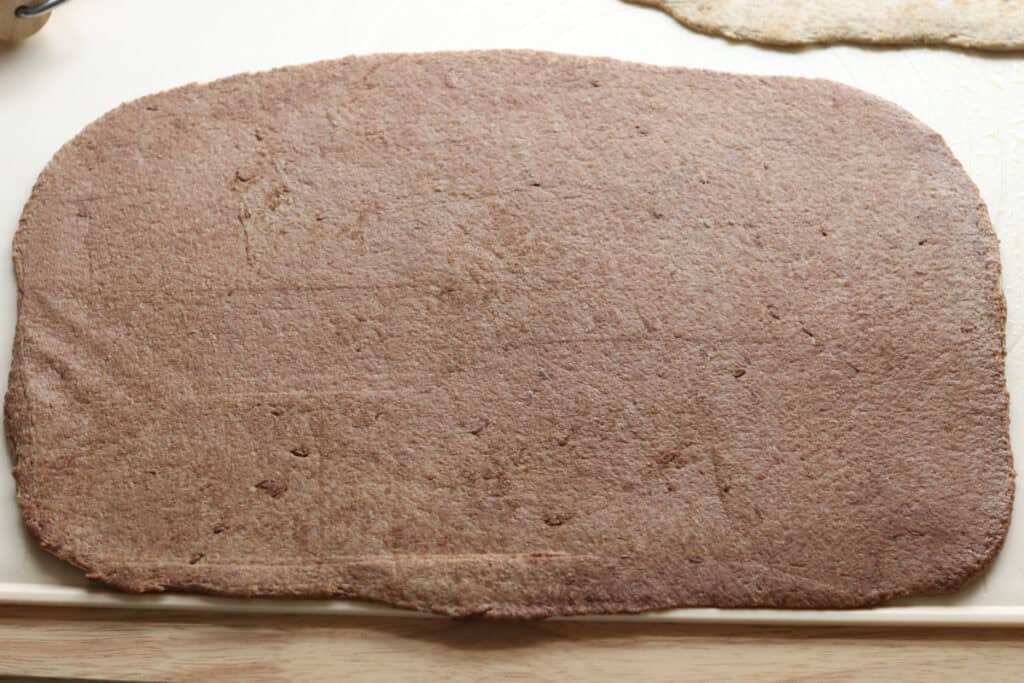 fresh milled dark rye dough rolled into a rectangle