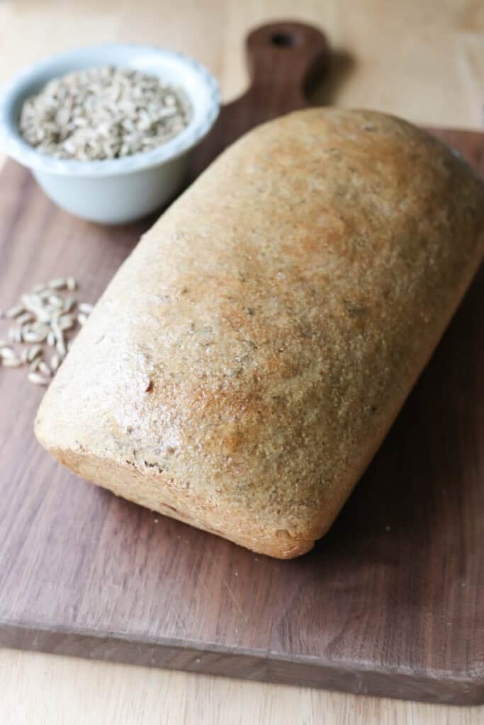 a loaf of freshly milled marbled rye bread on a wooden cutting board