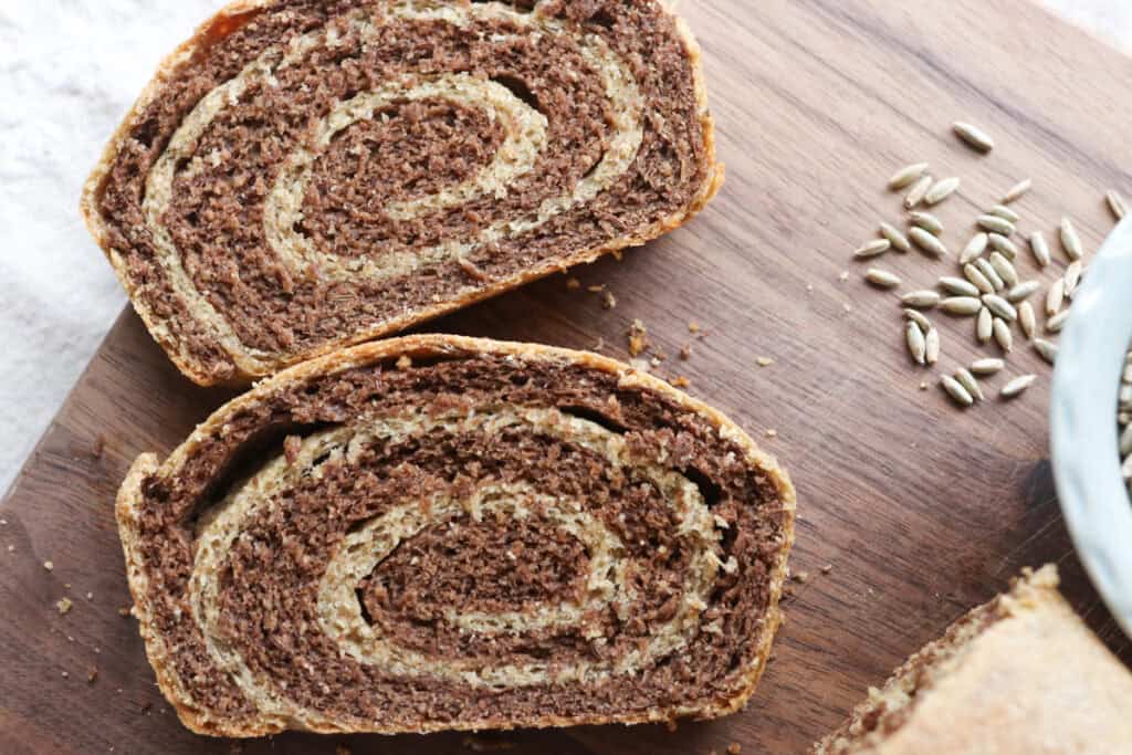 two slices of freshly milled marbled rye bread with rye wheat berries
