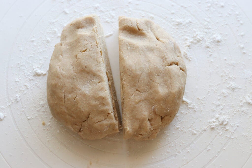 the dough for Homemade Fresh Milled Cinnamon Toast Crunch Cereal divided in half on a pastry mat