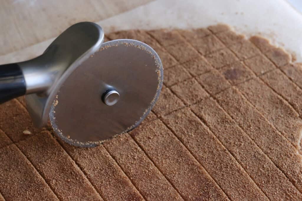 cutting the dough for Homemade Fresh Milled Cinnamon Toast Crunch Cereal