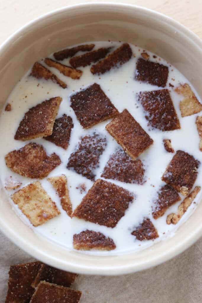 Homemade Fresh Milled Cinnamon Toast Crunch Cereal in a tan bowl with milk