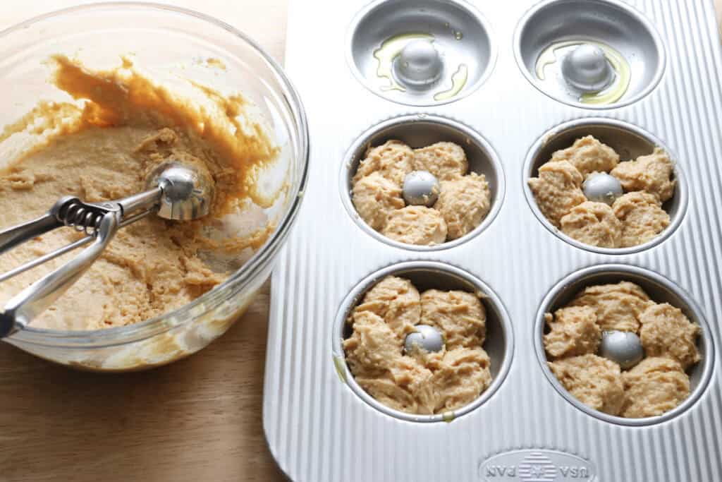 a donut pan with batter in it to make Homemade Baked Spring Donuts with Fresh Milled Flour