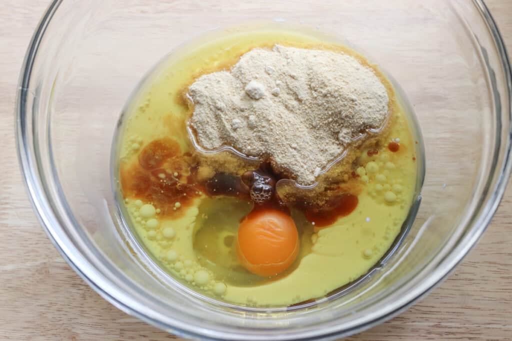 sugar, oil, and egg in a glass bowl to make freshly milled glazed strawberry bread