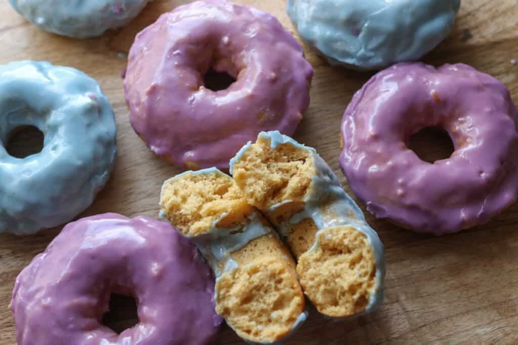 Homemade Baked Spring Donuts with Fresh Milled Flour on a wooden board with one cut in half