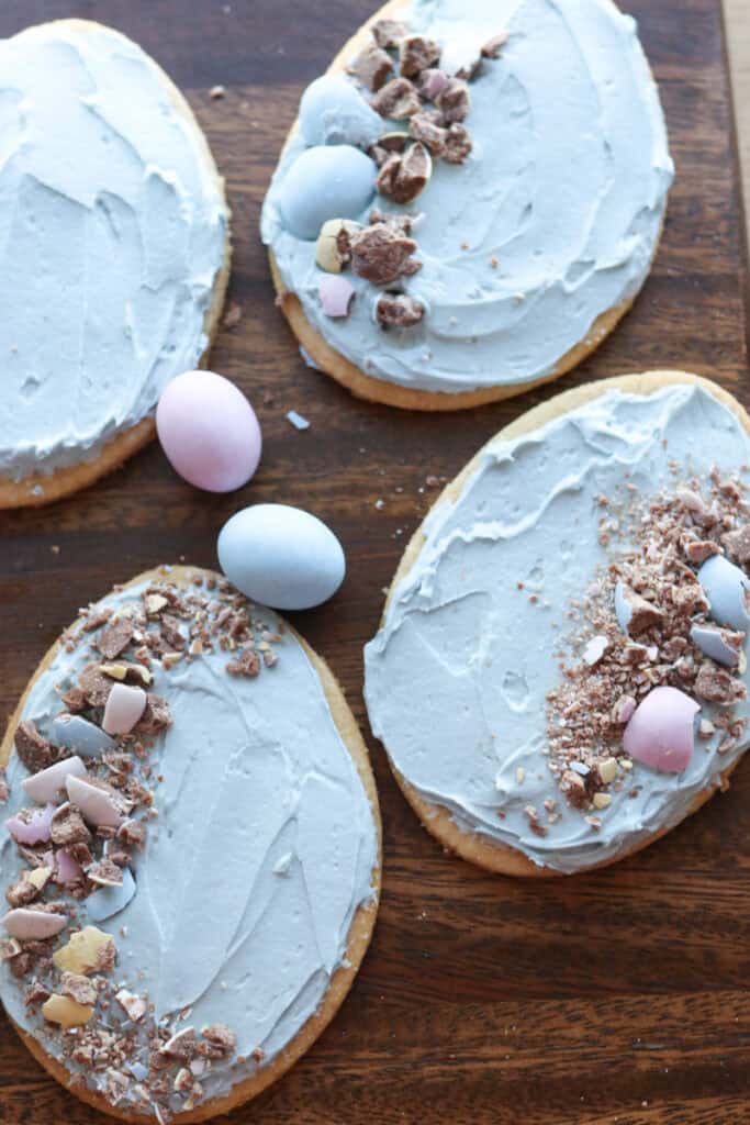 Fresh milled Easter egg sugar cookies with blue frosting and chocolate eggs