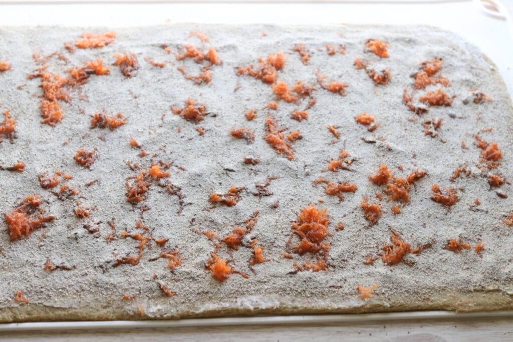 Cinnamon and sugar added to Fresh milled carrot cake cinnamon roll