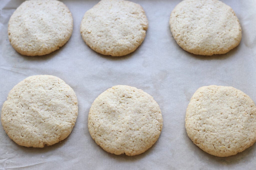 Fresh milled lemon cookies on a cookie sheet that have been baked
