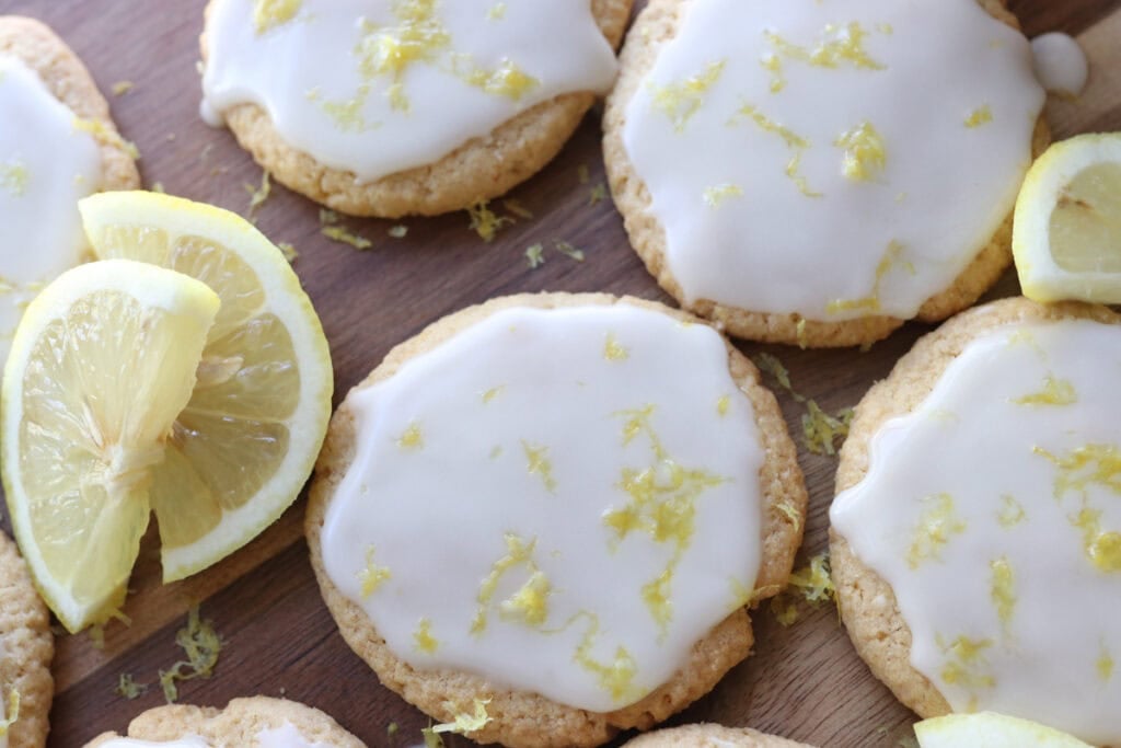 Fresh milled glazed lemon cookies on a wooden board
