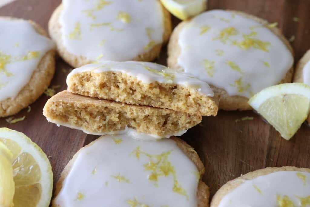 Fresh milled glazed lemon cookies with one broken in half