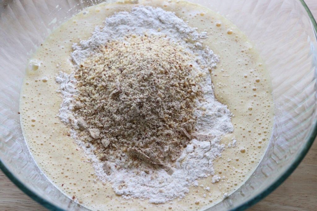 ground almonds and flour in a glass bowl folded into the batter to make a fresh milled almond croissant cake