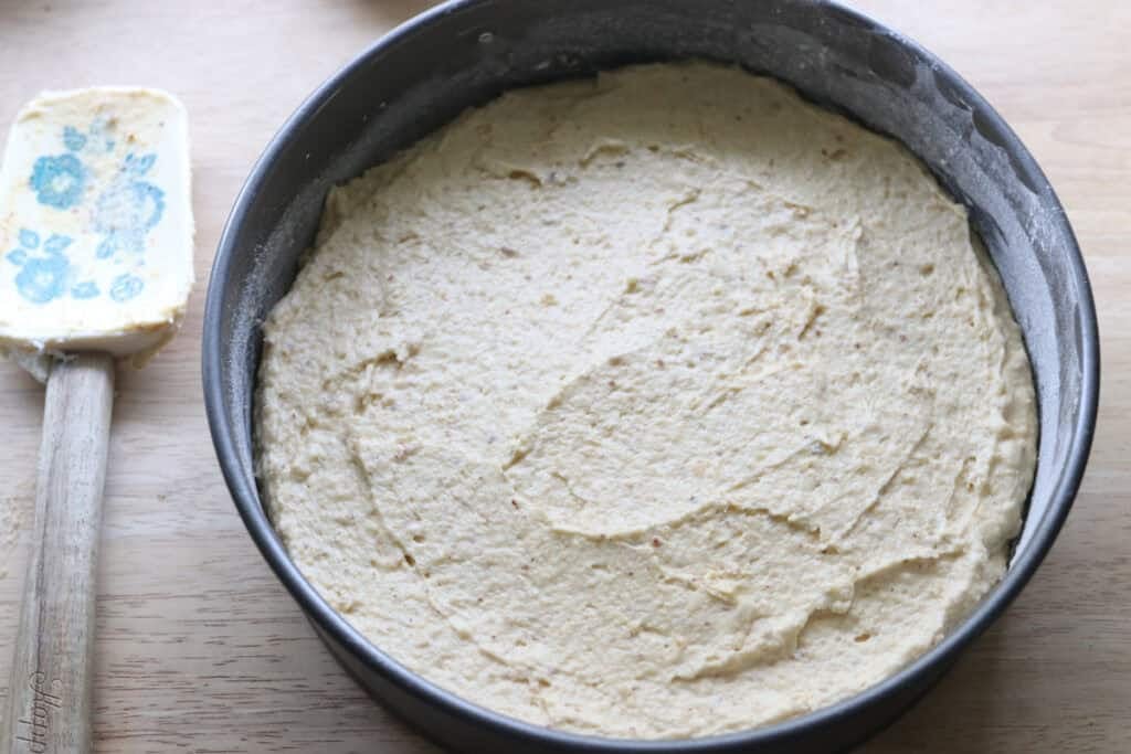 fresh milled almond croissant cake batter spread into a springform pan