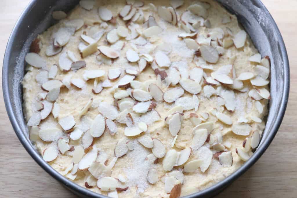 fresh milled almond croissant cake topped with sliced almonds and sugar