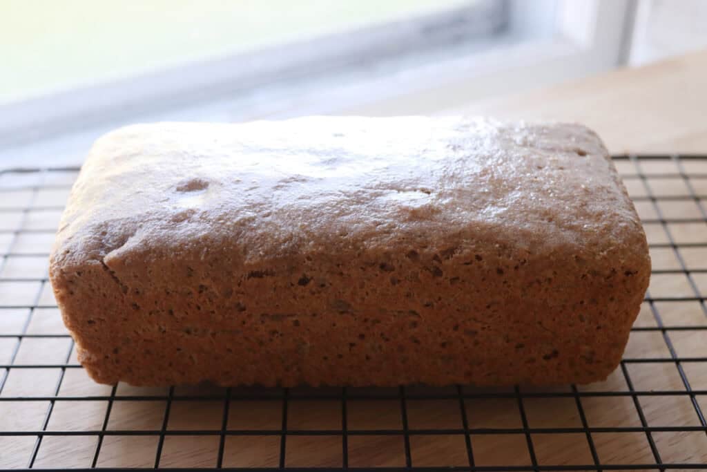 Freshly milled einkorn sandwich bread cooling on a wire rack