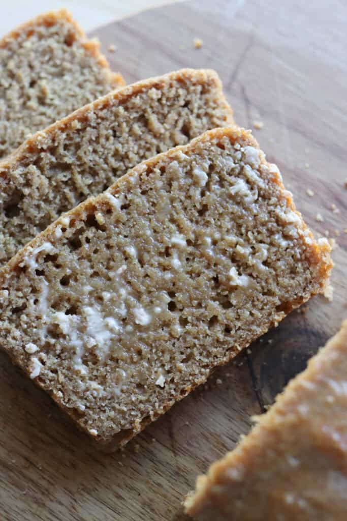 a slice of freshly milled einkorn sandwich bread covered in butter