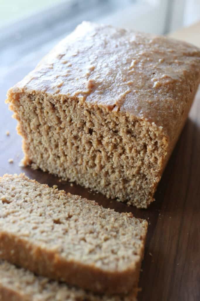 Freshly milled einkorn sandwich bread cut in half and topped with butter