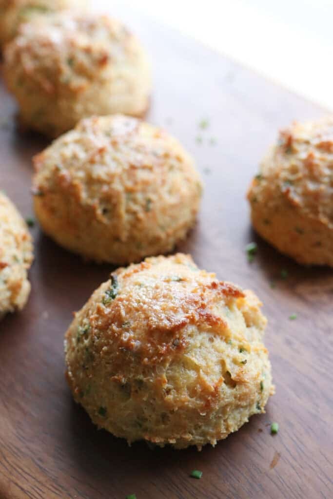A Freshly Milled Parmesan Chive Drop Biscuit covered in butter