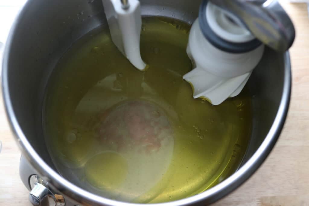 oil, honey, and water in a bowl to make freshly milled lemon poppy seed rolls