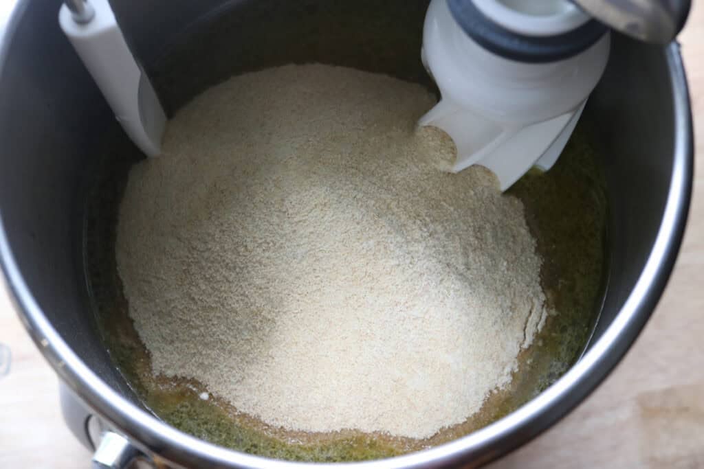 flour added to the mixing bowl for freshly milled lemon poppy seed rolls