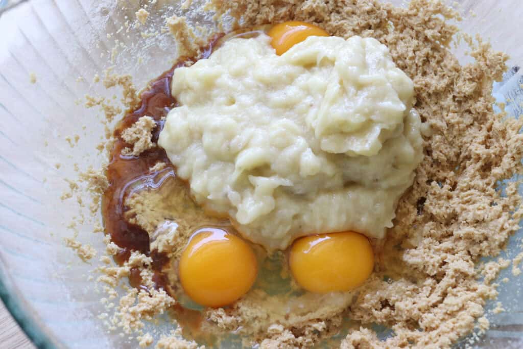 eggs and mashed banana added to the bowl to make freshly milled frosted banana bars