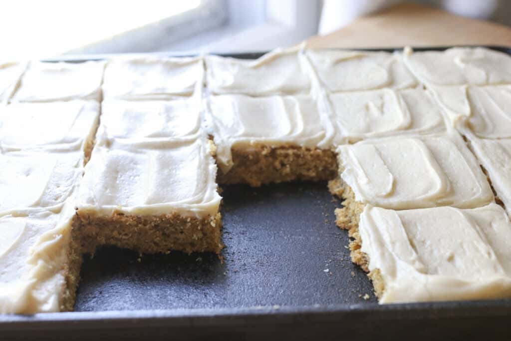 freshly milled frosted banana bars in a black cast iron pan