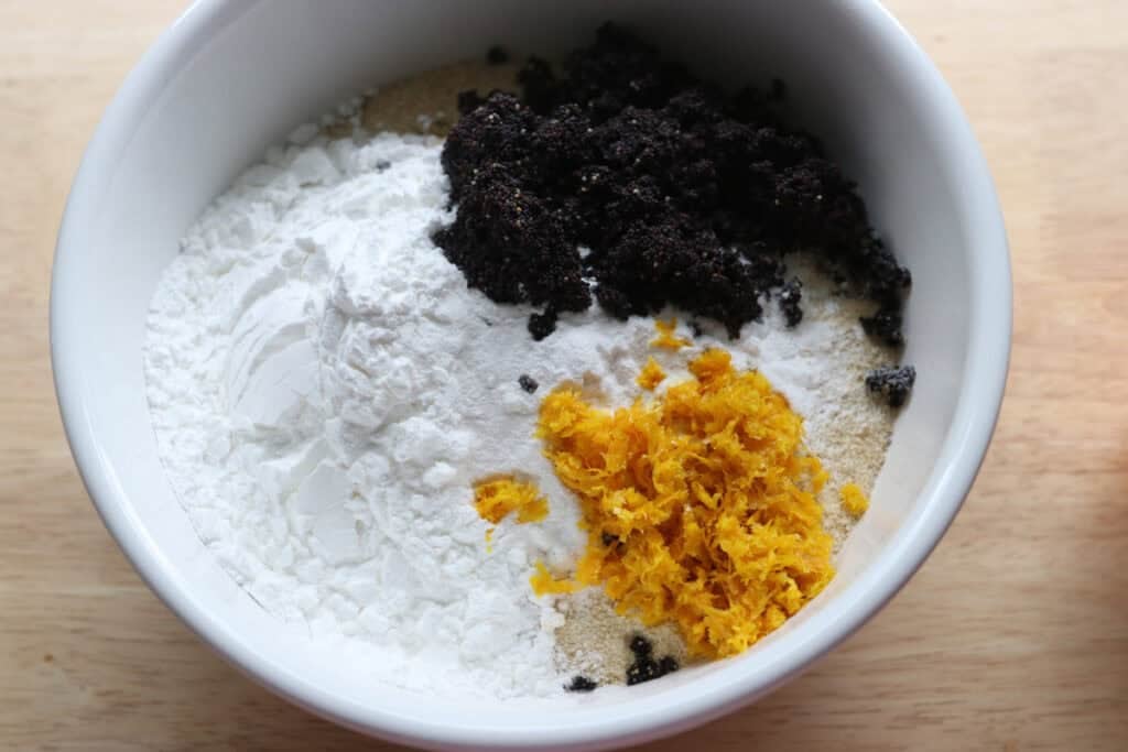 poppy seeds, orange zest, and flour in a bowl to make the Freshly milled orange almond poppy seed cake
