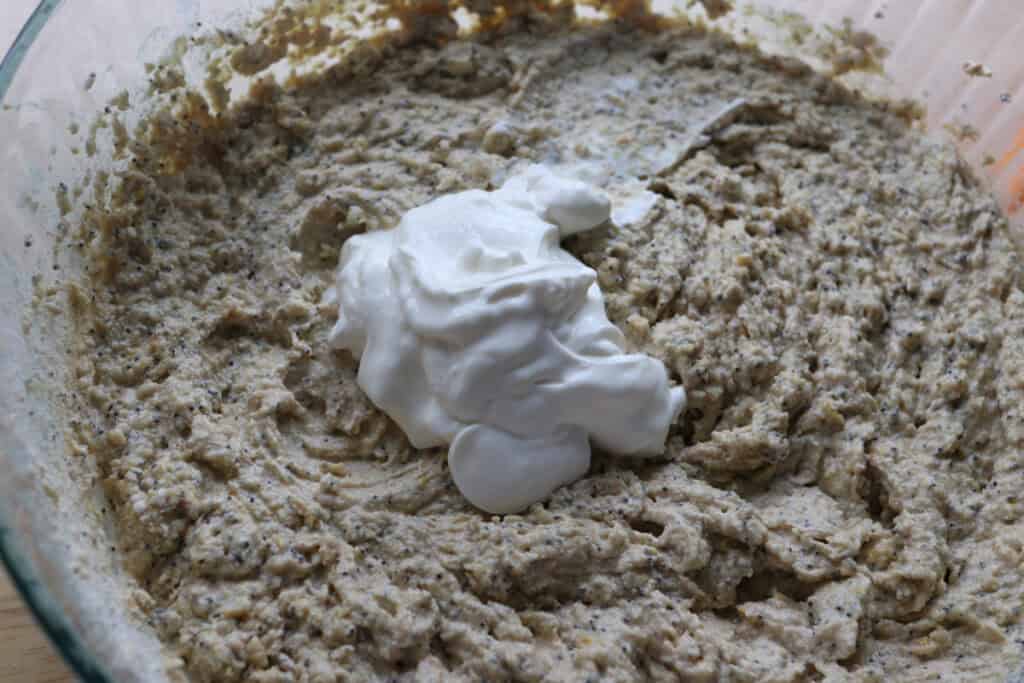 adding sour cream to the Freshly milled orange almond poppy seed cake batter