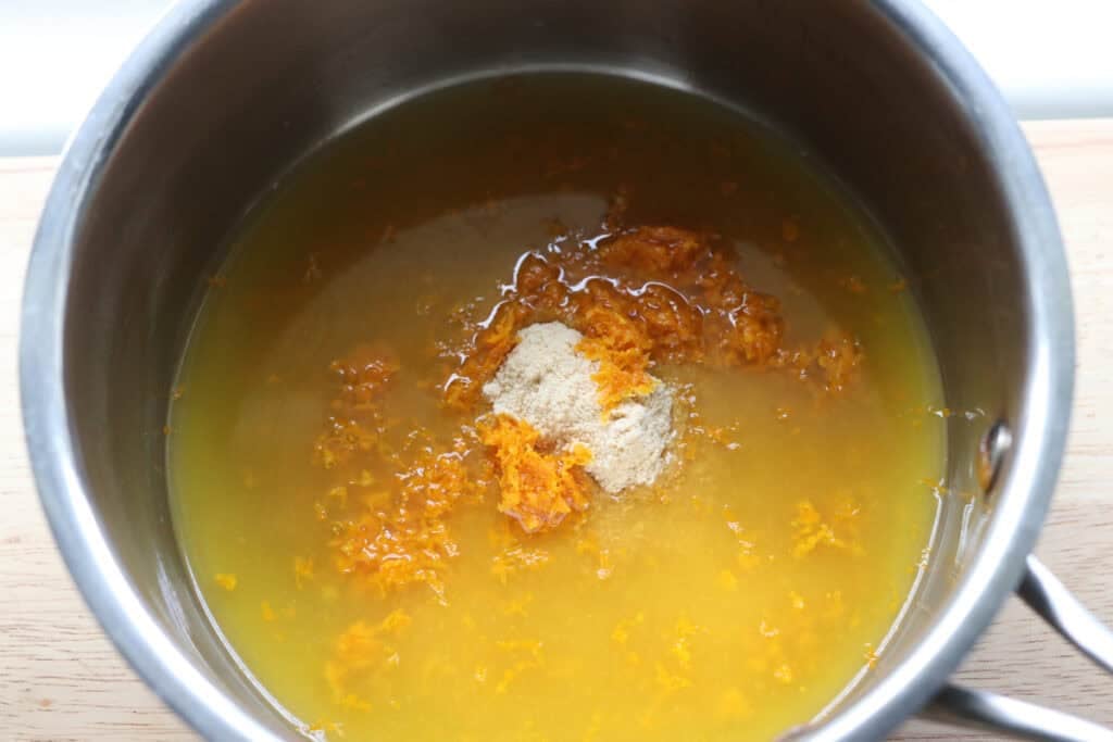 orange zest and juice in a pot to make the orange curd for the Freshly milled orange almond poppy seed cake
