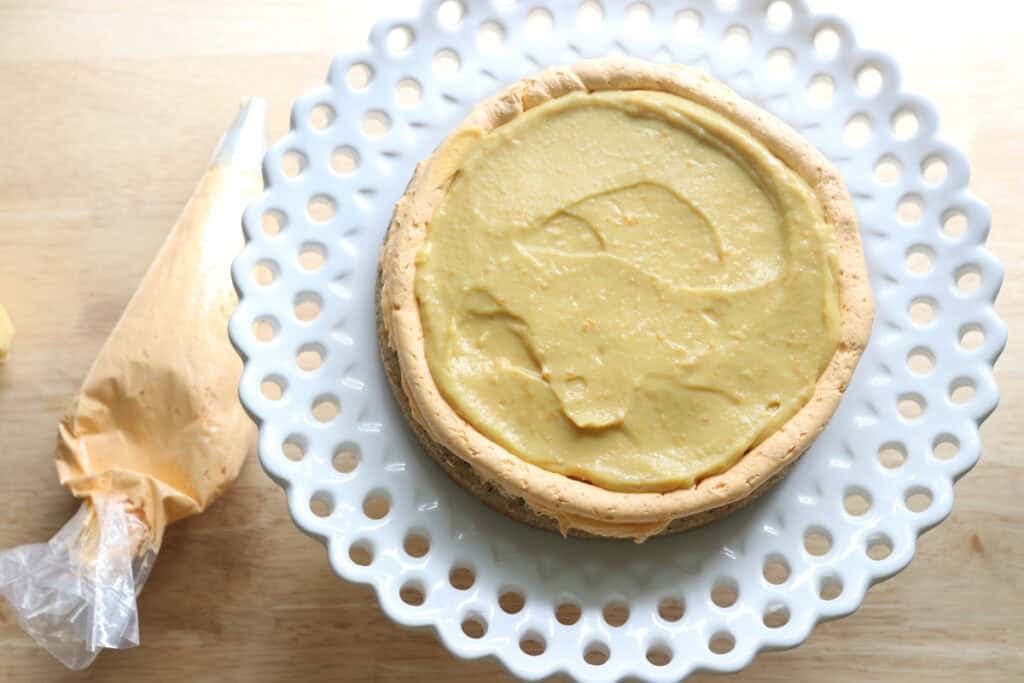 a layer Freshly milled orange almond poppy seed cake covered with buttercream and filled with lemon curd