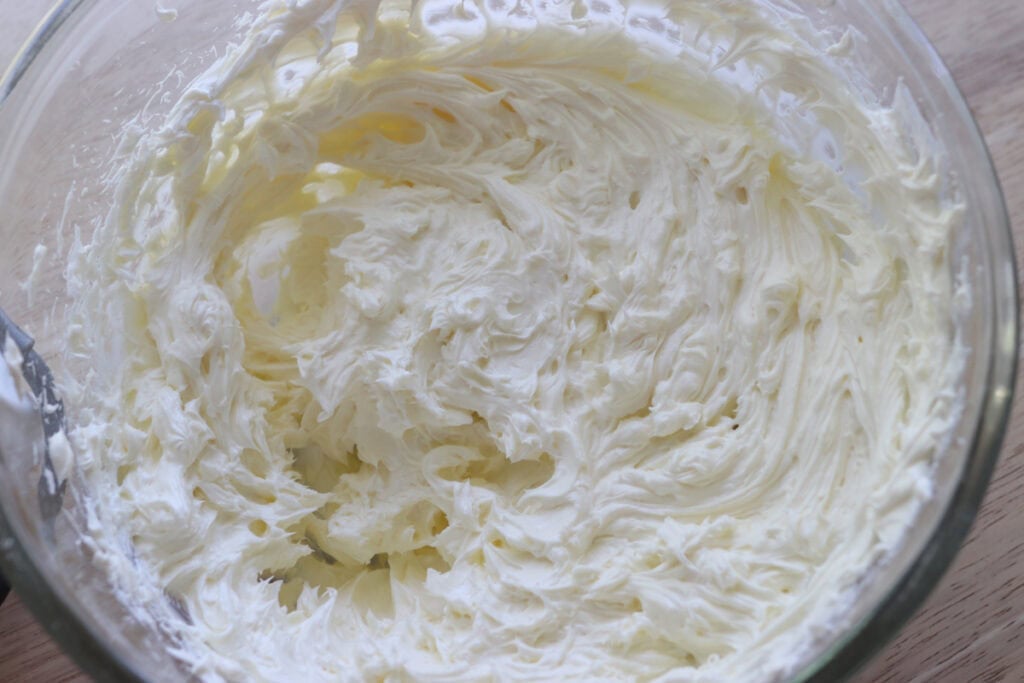 cream cheese that has been whipped to make freshly milled mango cheesecake bars
