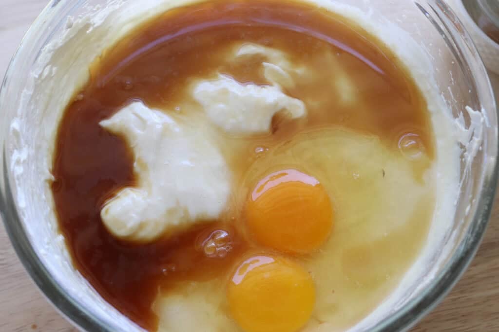 vanilla and eggs in the mixing bowl to make freshly milled mango cheesecake bars
