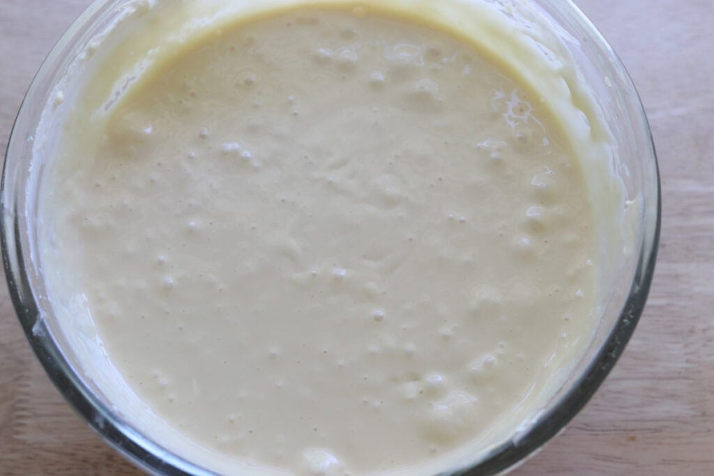 mango cheesecake batter in a glass bowl