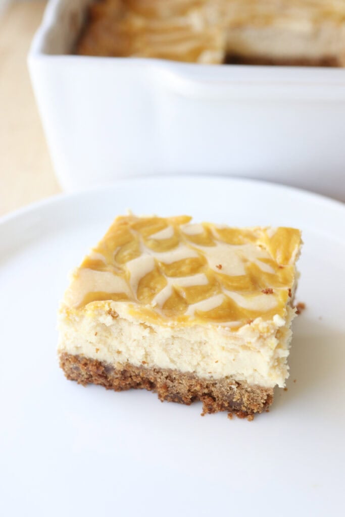 a slice of freshly milled mango cheesecake on a white plate