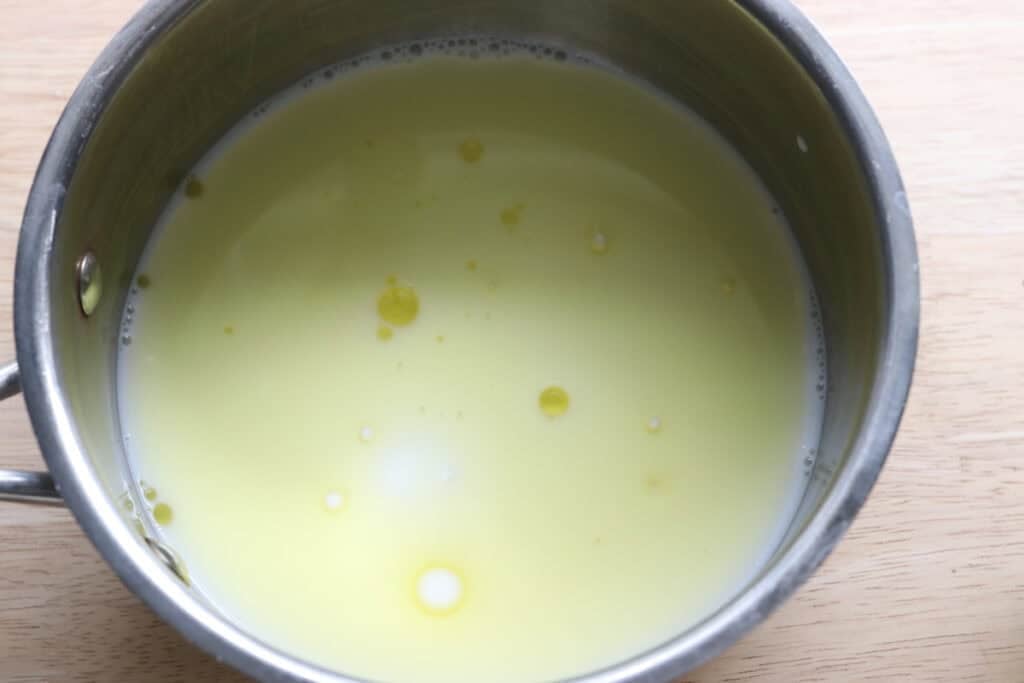 Milk and oil in a saucepan to make freshly milled english muffin toasting bread