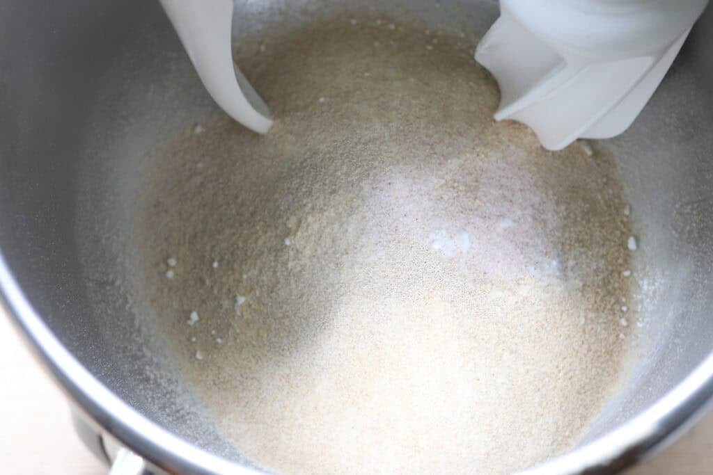 flour and baking soda added to a mixing bowl to make freshly milled English muffin toasting bread