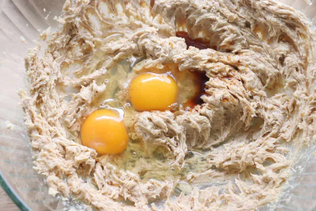 eggs and vanilla added to the bowl to make freshly milled blueberry cheesecake oatmeal cream pies