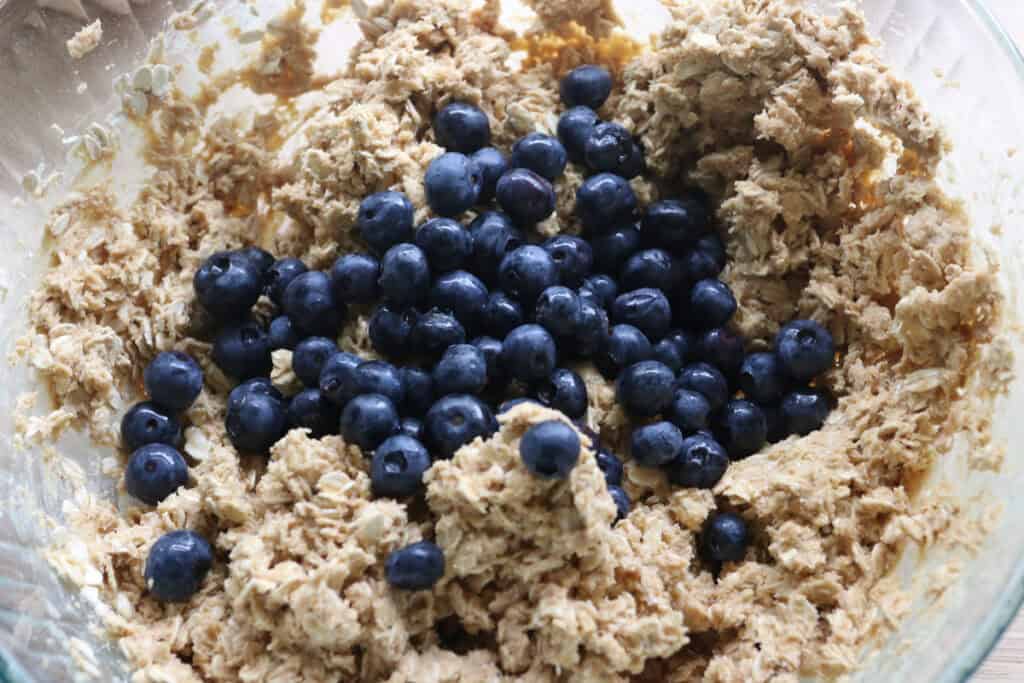 blueberries added to the batter for freshly milled blueberry cheesecake oatmeal cream pies