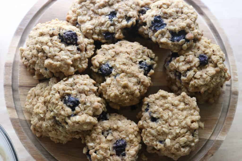 freshly milled blueberry cheesecake oatmeal cream pie cookies on a cake stand