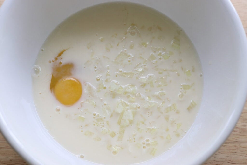 egg and milk in a bowl to make freshly milled hush puppies