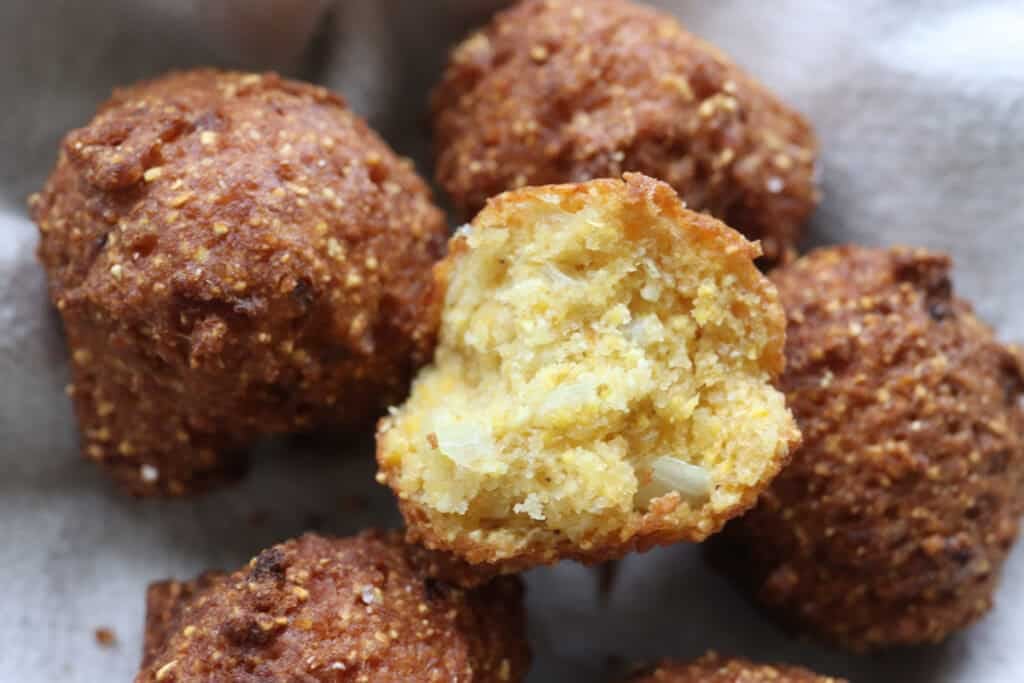 Freshly milled hush puppies with one torn in half