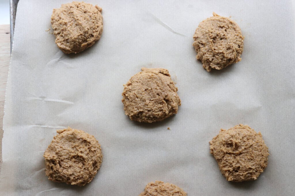Freshly milled tiramisu cookie dough scooped onto a cookie sheet