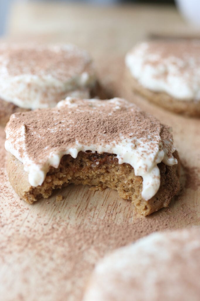 a Freshly milled tiramisu cookie with a bite taken out of it