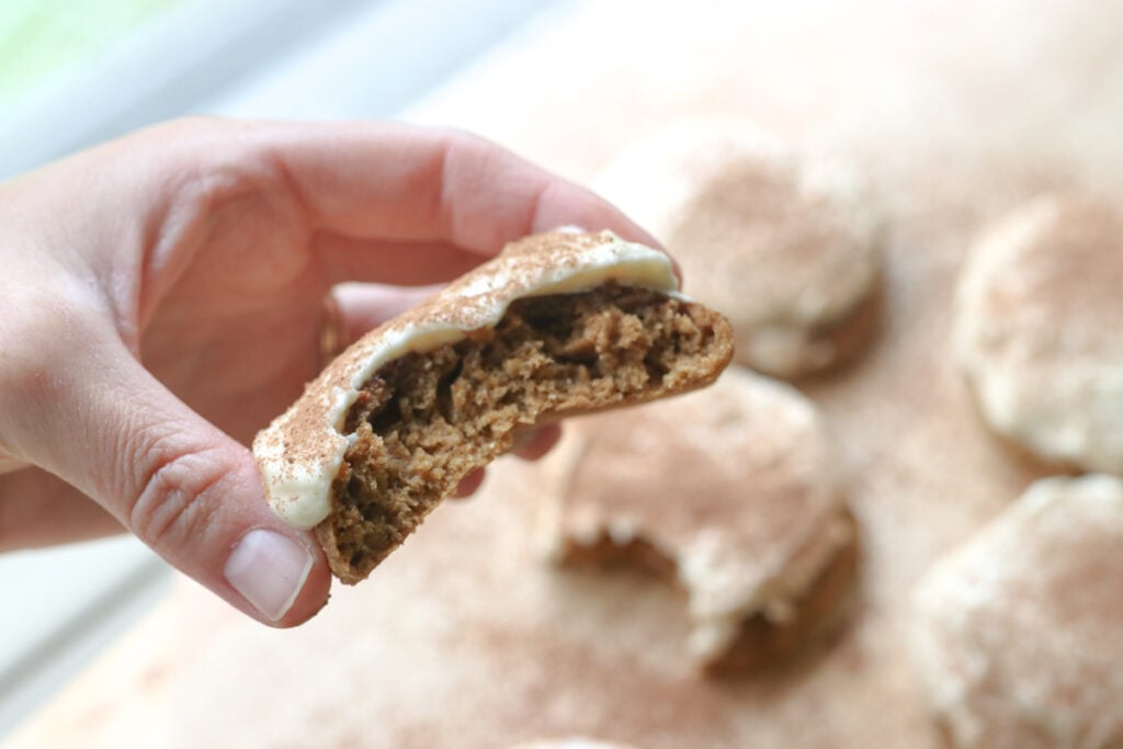 someone holding half of a Freshly milled tiramisu cookie